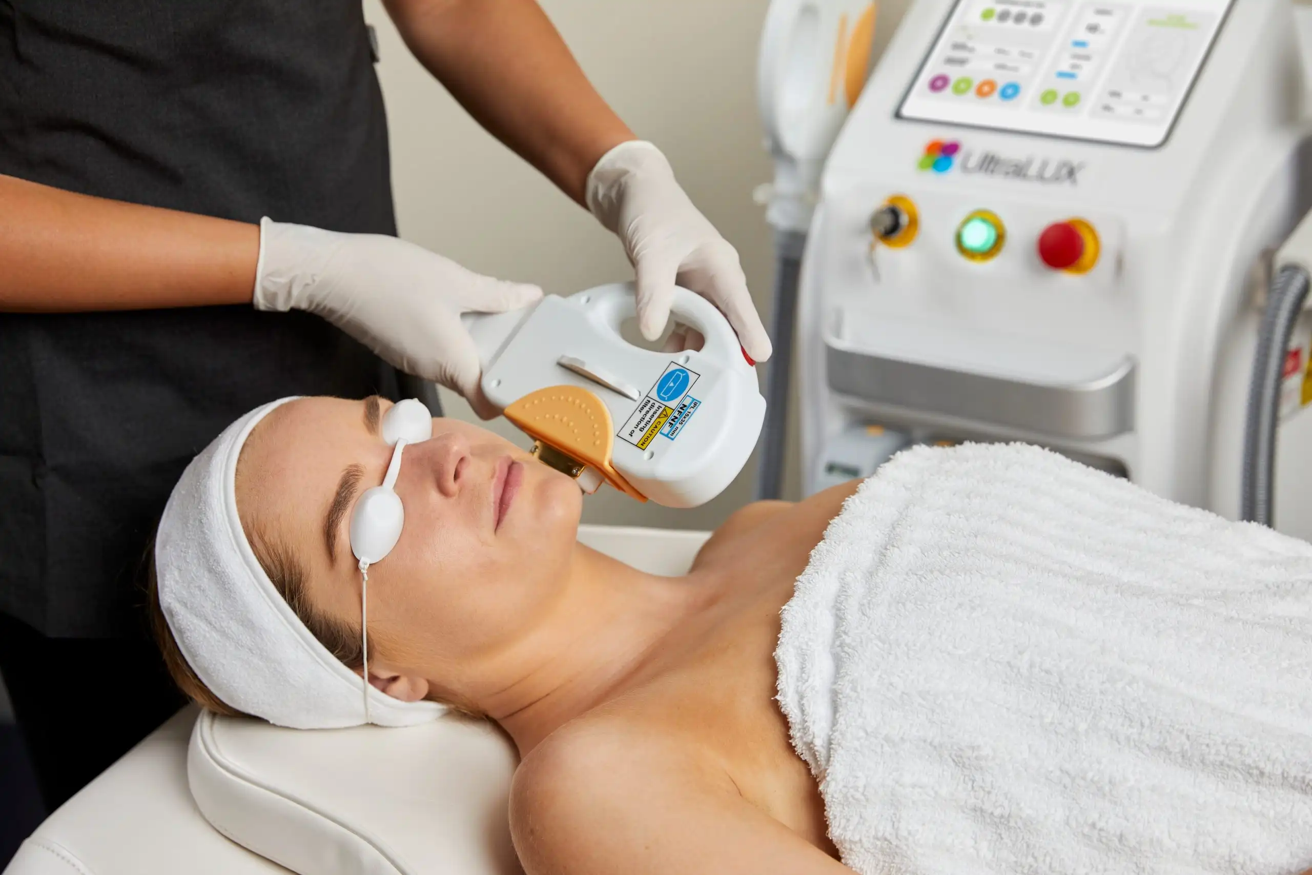 Woman receiving a IPL Pigmentation treatment in clinic setting