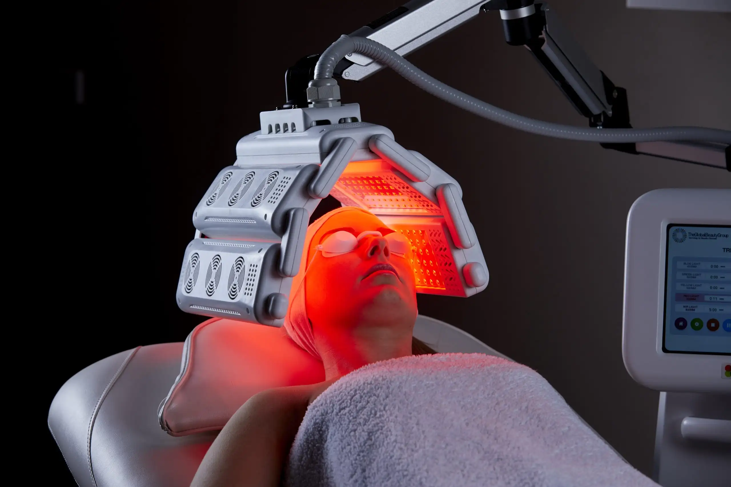 Woman undergoing red LED light facial therapy